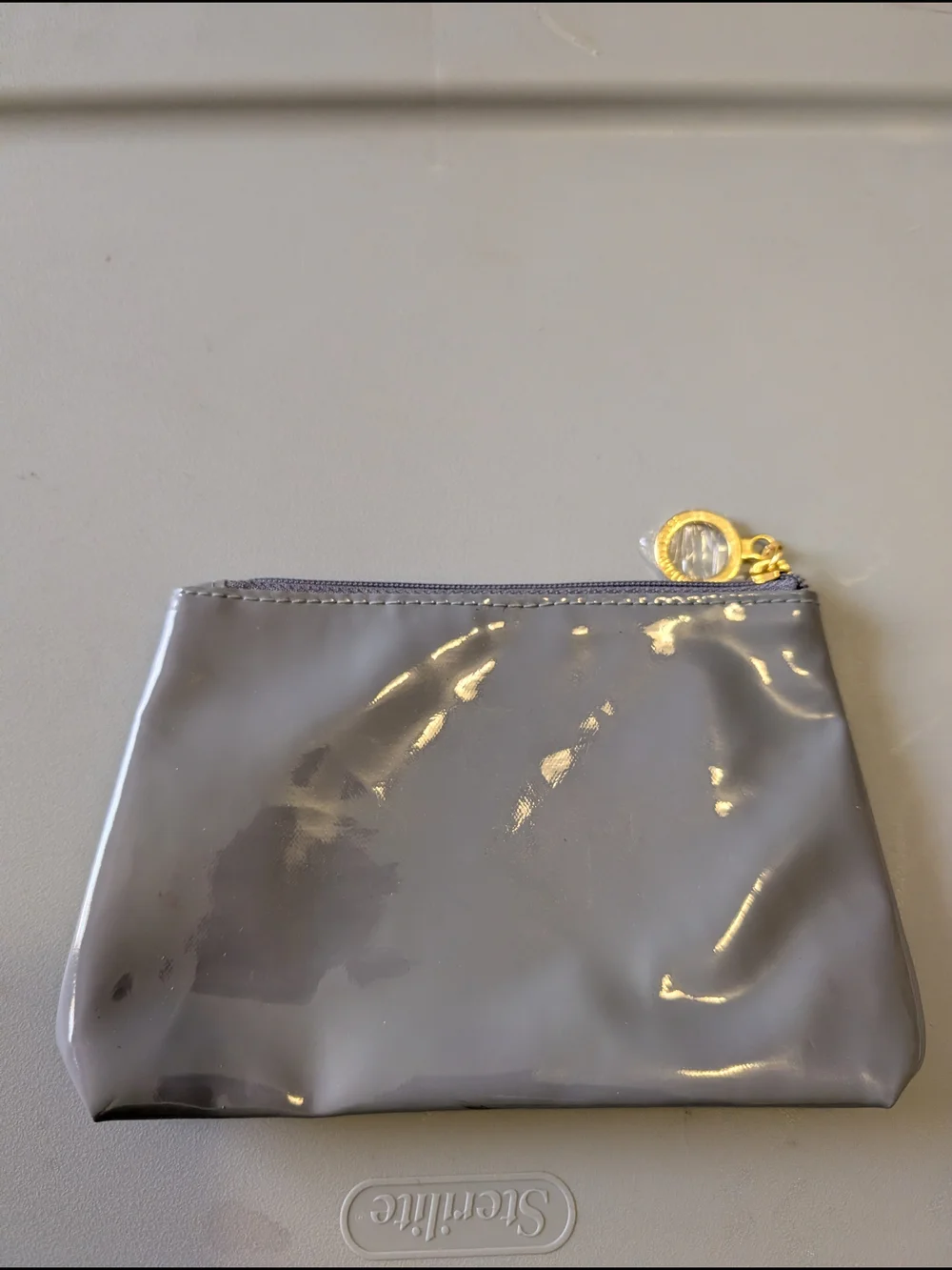 Estee Lauder grey patent makeup bag gold zipper pull pouch women
